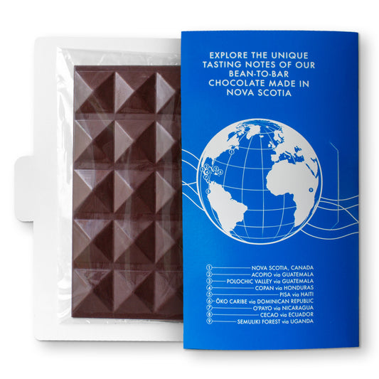 A chocolate bar made with organic cacao beans from CECAO, Ecuador, packaged in a transparent wrapper with a blue branding card showing the brand and product information.